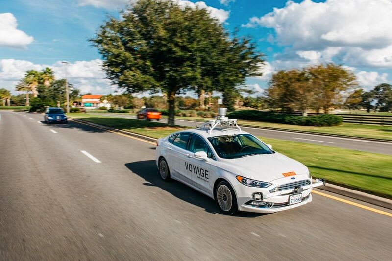 Figure 1.  A Voyage self-driving taxi on the road at The Villages community in Florida.